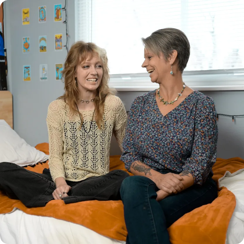 A lady with her girl child are smiling.