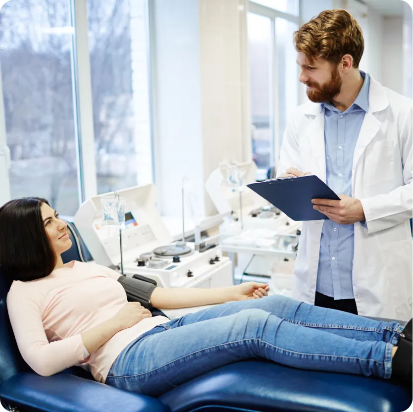 A young woman and her doctor during the plasma donation process.