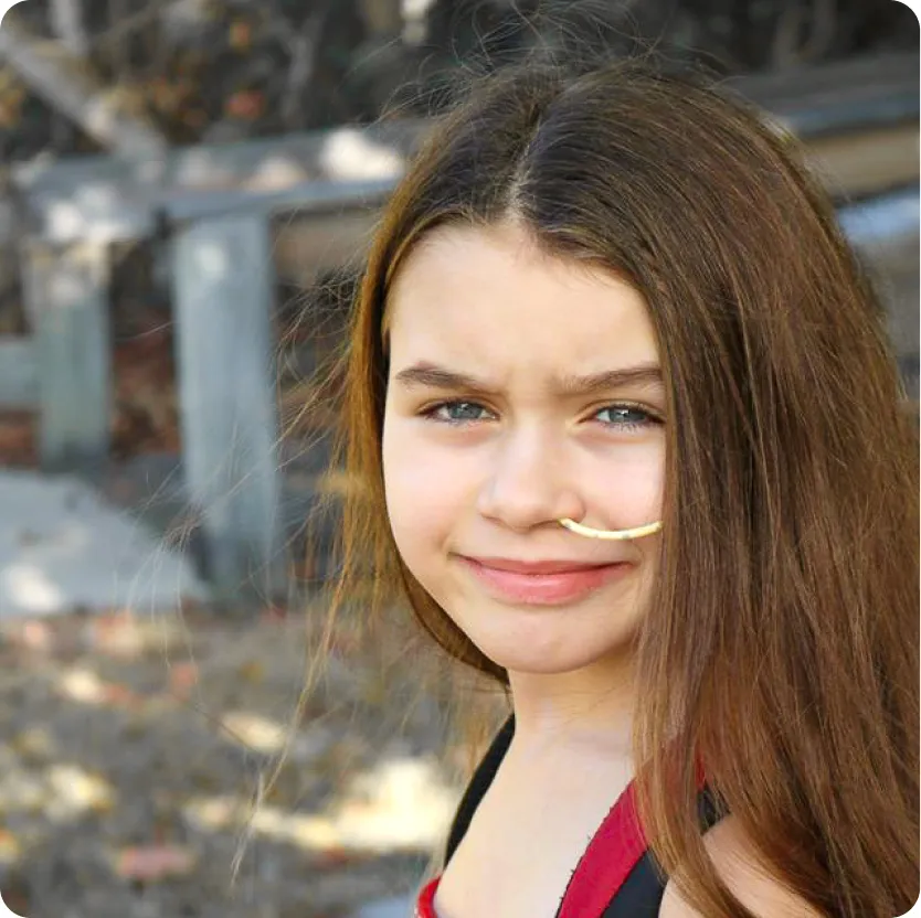 A little girl smiling.