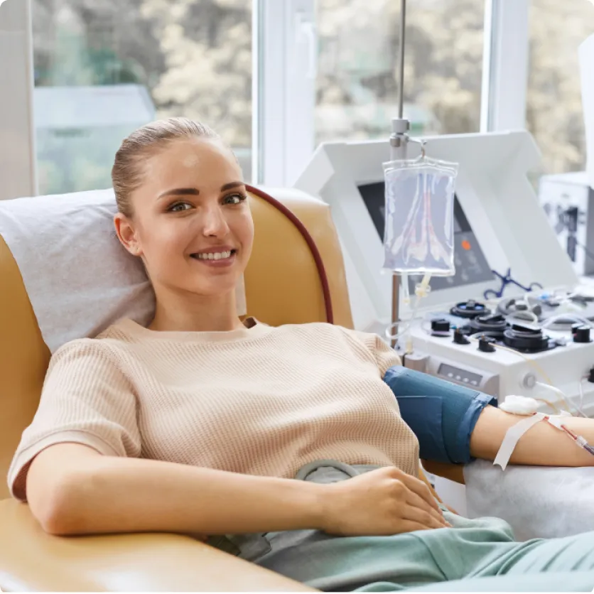 A young woman during the plasma donation process.