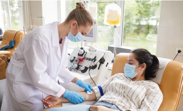 The woman is making a plasma donation