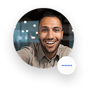 Smiling man with short hair and a beard in an office setting.