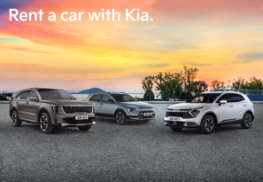 Three Kia cars parked on a paved area at sunset, with the text "Rent a car with Kia."
