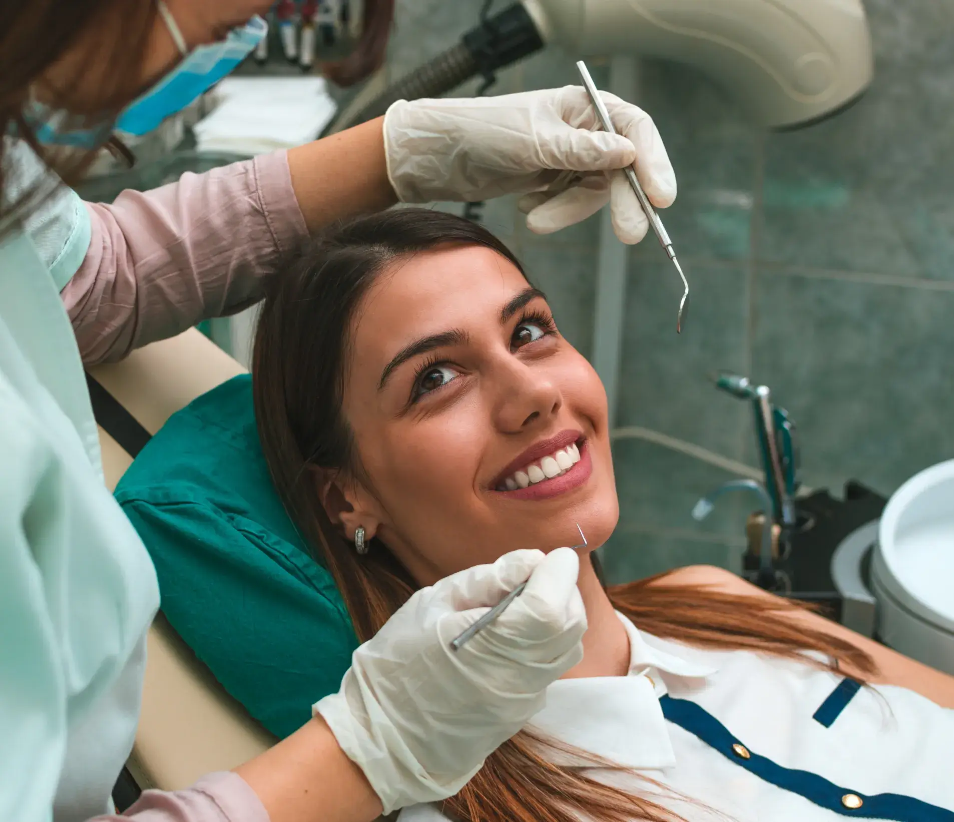 A woman getting her teeth checked by a dentist.