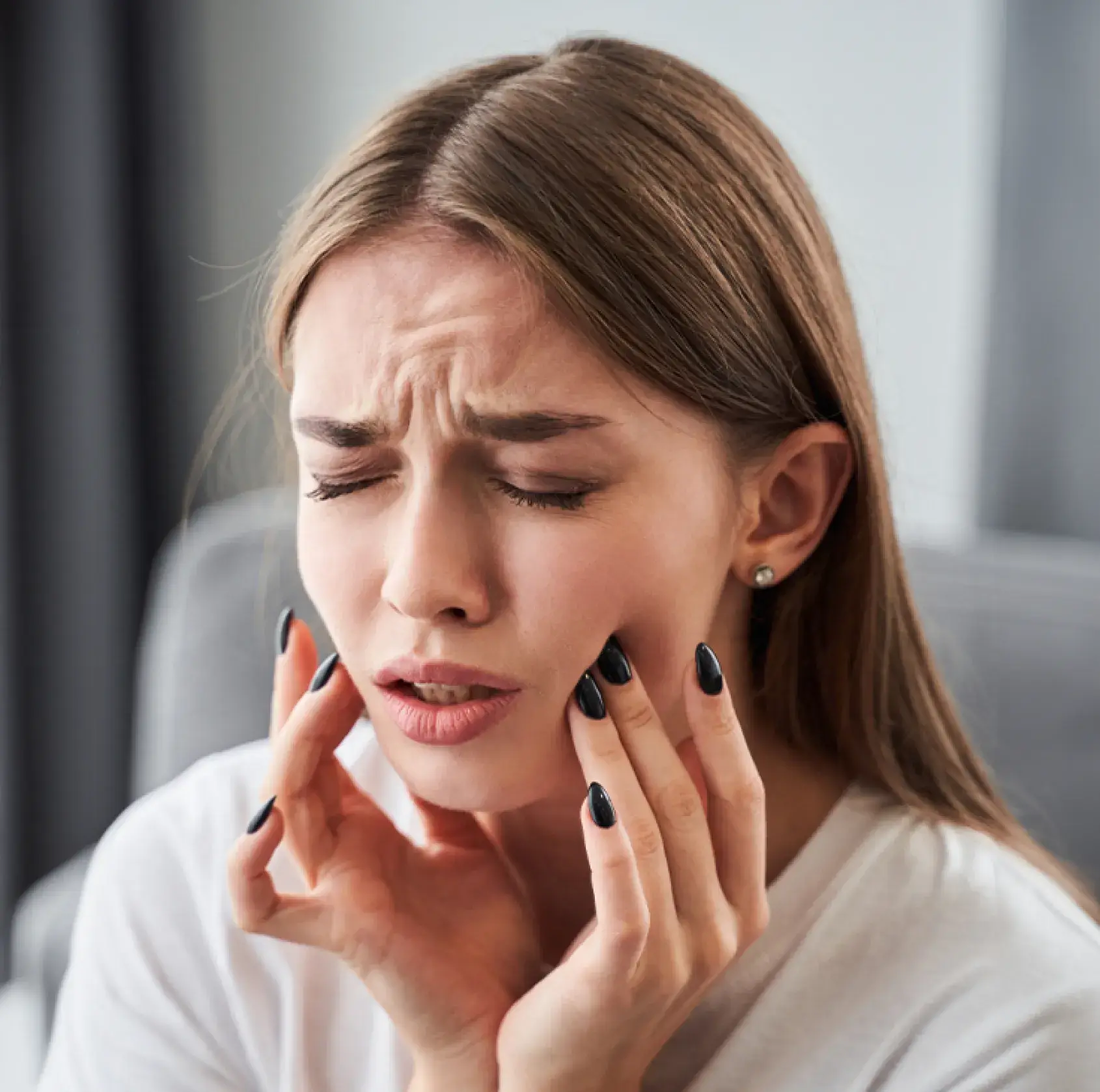 A woman holding her hands to her face.