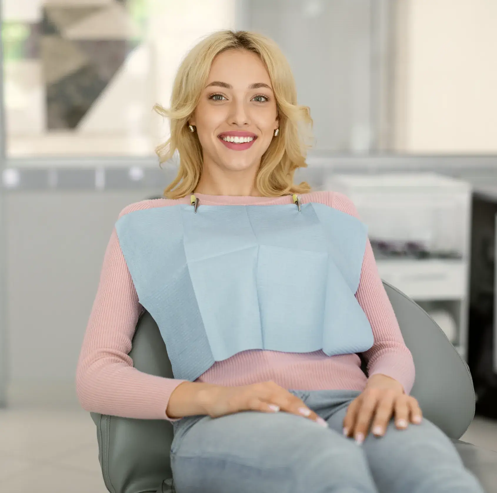A woman sitting in a chair with a smile on her face.