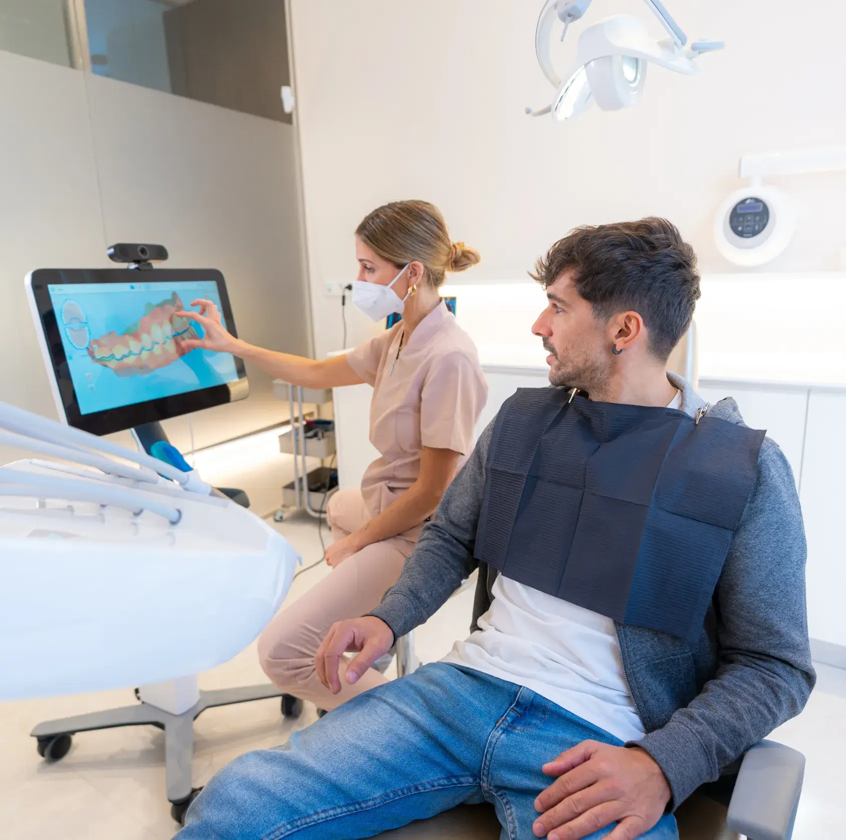A man and a woman in a dental room.
