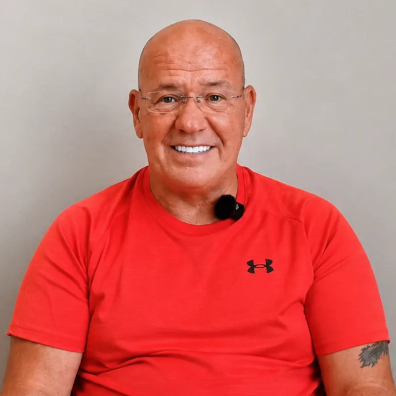 John Joyce smiling with his new teeth after treatment with Implantly