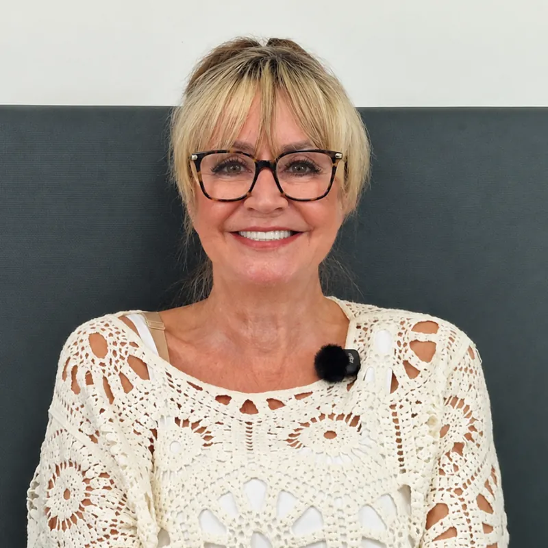 Kerry smiling with her new teeth after treatment with Implantly