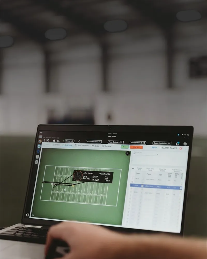 Laptop screen displaying a football field diagram and player stats for John Norton, an Old School QB, with detailed game metrics and play data.