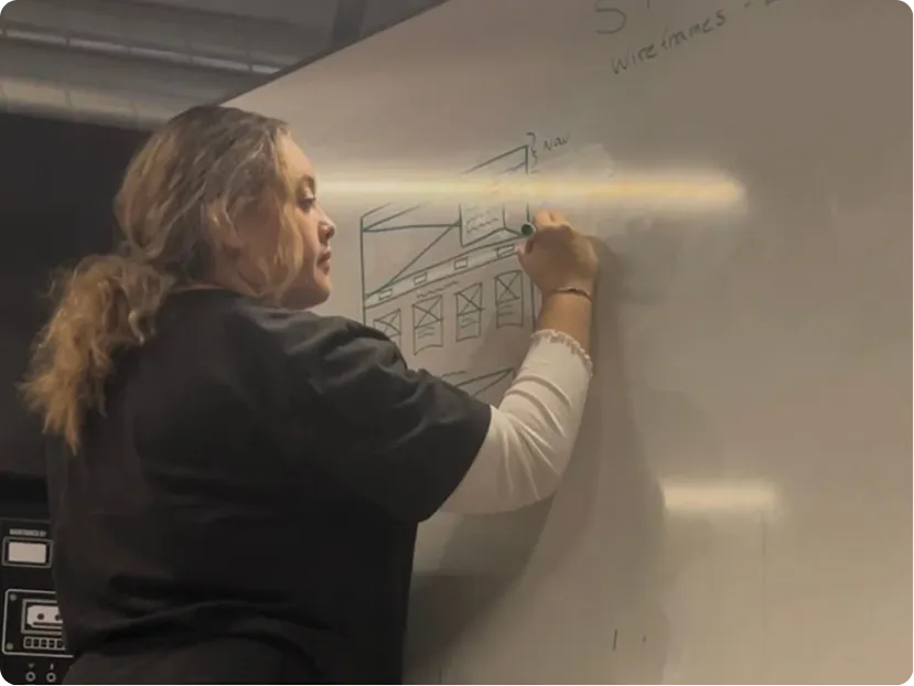 UX/UI designer (Casandra) creating whiteboard wireframes for the STairs healthcare education platform during an ideation and structure worksho