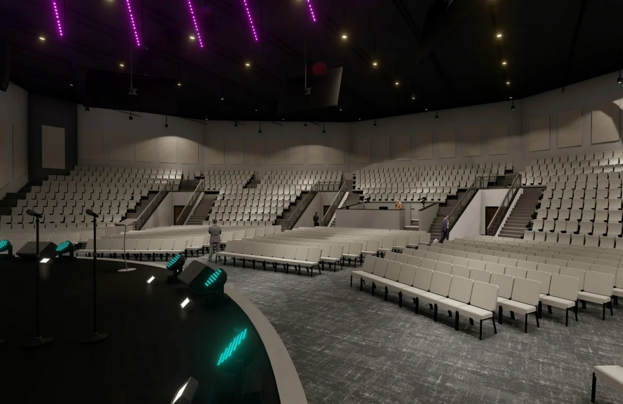 Modern church auditorium interior with curved stage, microphones, beige seating, and purple ceiling lights.
