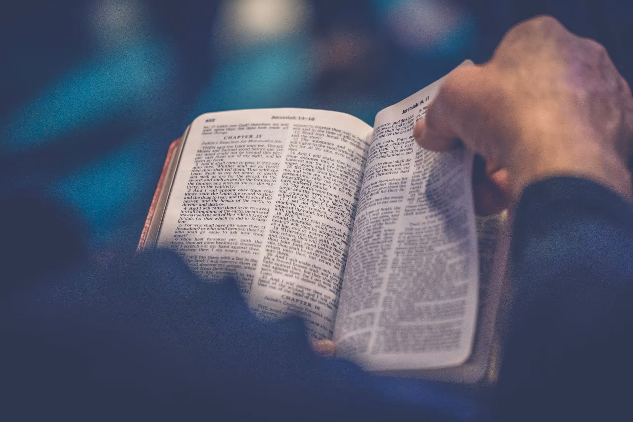 Person holding a Bible about to turn the page