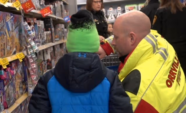 Firefighter Christmas shopping with child