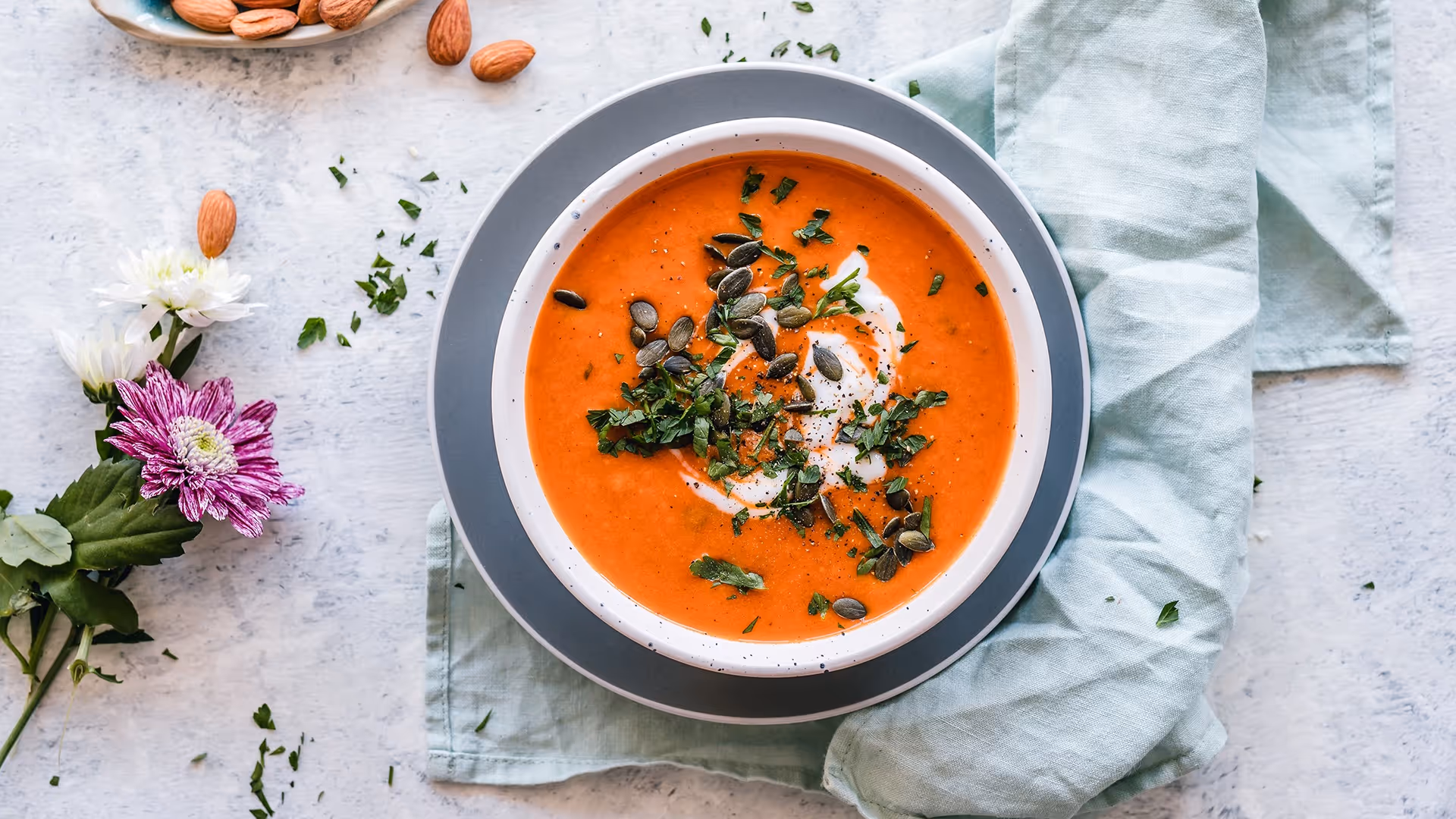 Bowl of squash soup with pumpkin seeds sprinkled on top