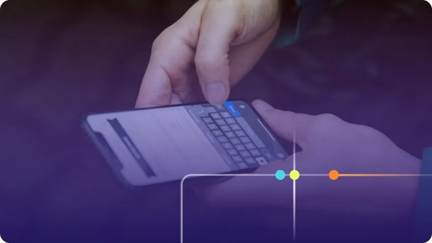 Close-up of hands typing on a smartphone with an on-screen keyboard