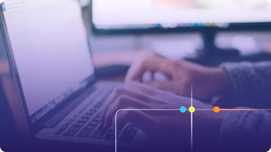 Close-up of hands typing on a laptop keyboard with a purple overlay and Focused brand accents