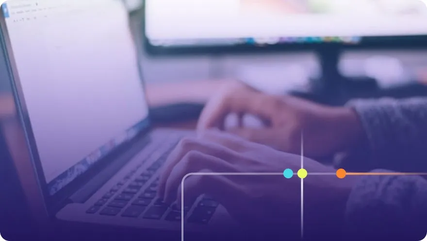 Close-up of hands typing on a laptop keyboard with a purple overlay and Focused brand accents