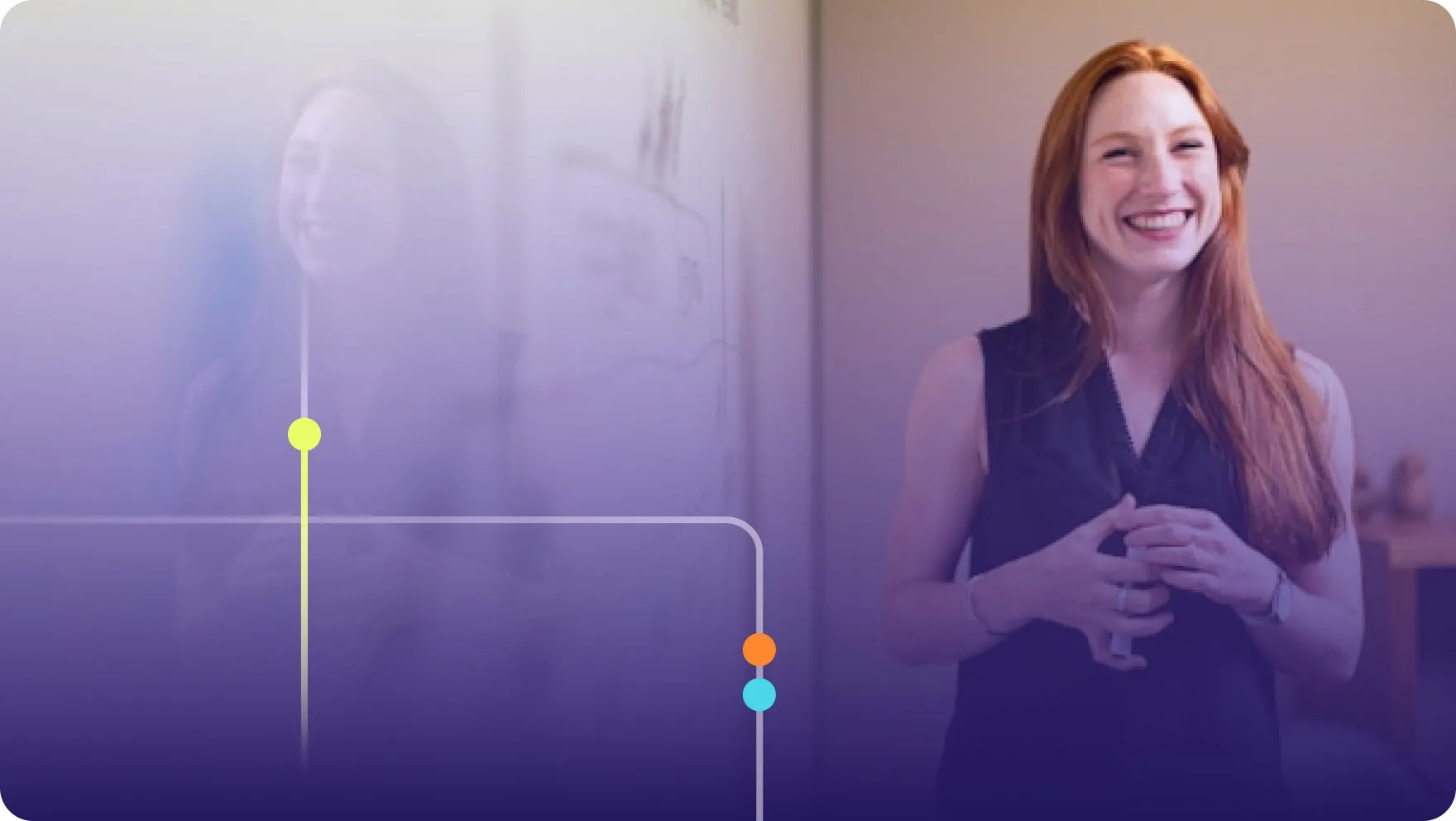 Woman smiling while presenting next to a whiteboard in a meeting room