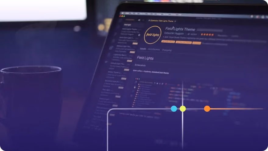 Laptop screen showing a VS Code editor with a dark theme extension page and a coffee mug nearby