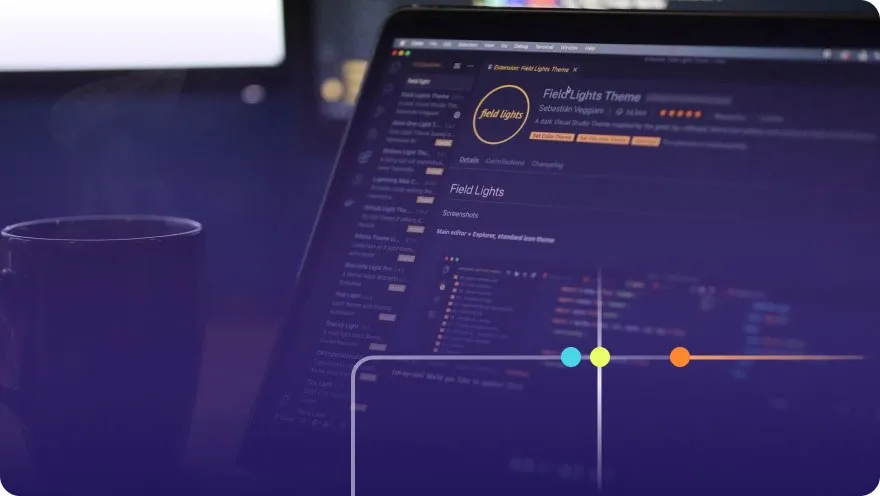 Laptop screen showing a VS Code editor with a dark theme extension page and a coffee mug nearby