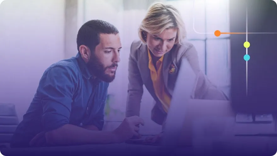 Two colleagues reviewing content on a computer screen together with a purple overlay