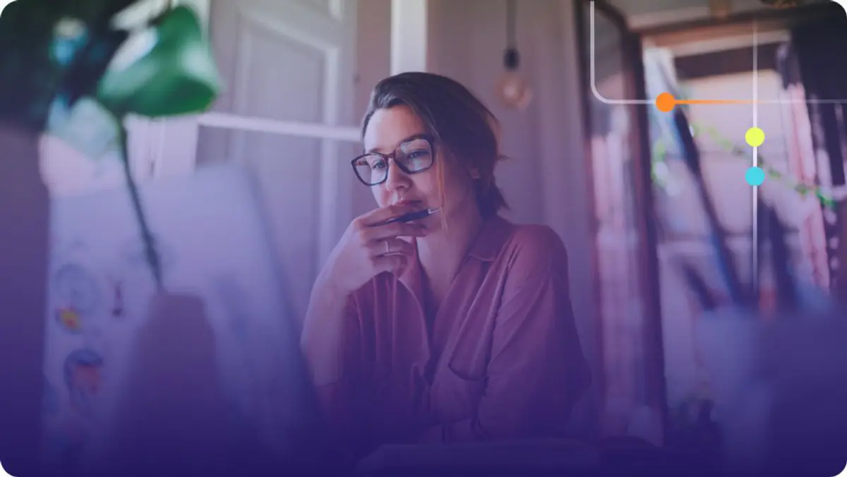 Woman with glasses holding a pen in thought at a desk with a purple overlay
