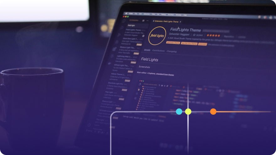 Laptop screen showing a VS Code editor with a dark theme extension page and a coffee mug nearby