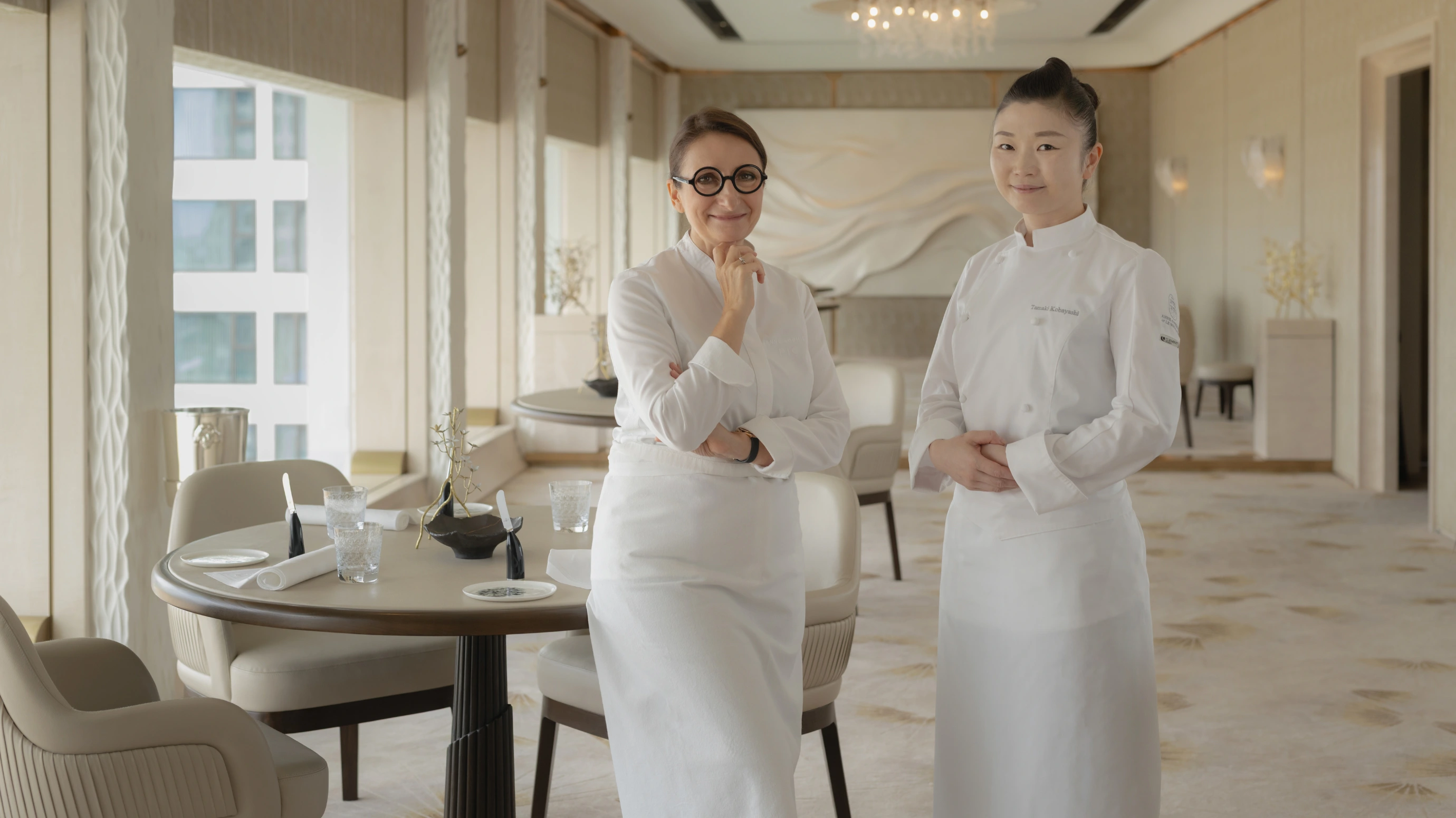 Anne-Sophie Pic et sa collaboratrice en salle, illustrant la transmission du savoir-faire au sein de la Maison.