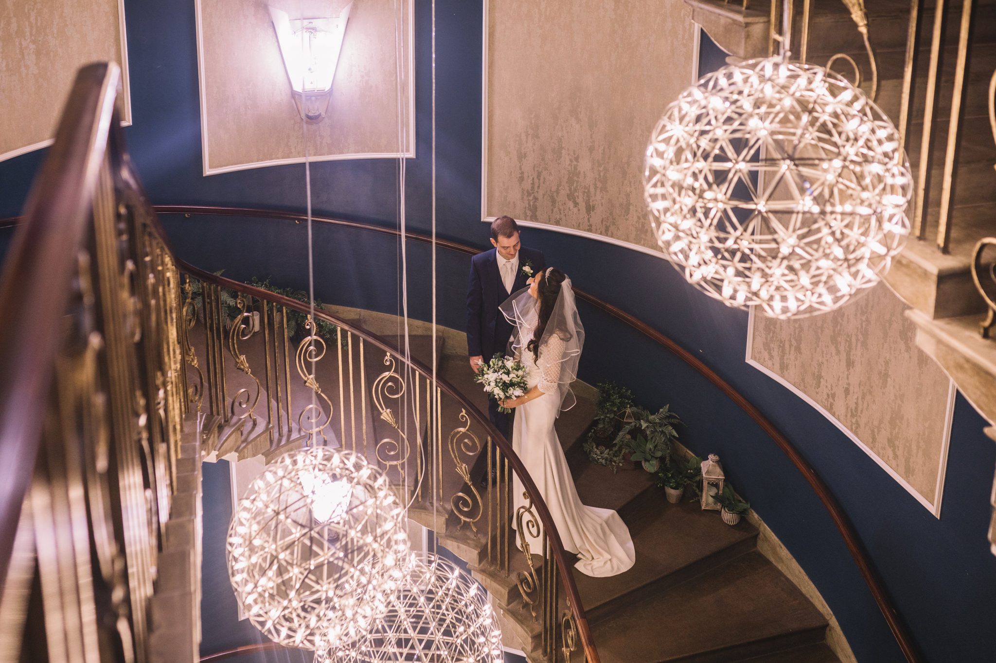 Bride and groom on the grand staircase at Manchester Hall