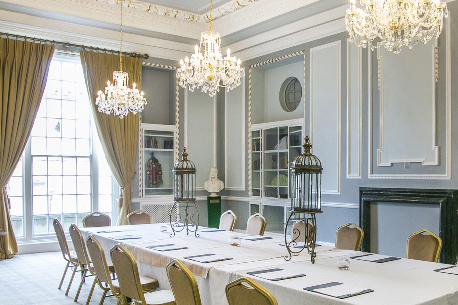 The Library at Manchester Hall with floor-to-ceiling bookshelves and black marble fireplace