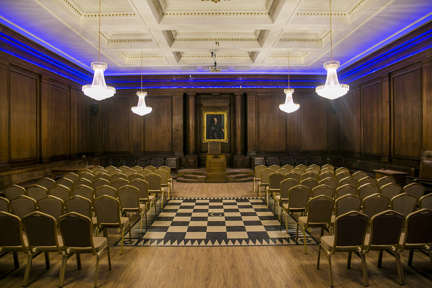 Historic Masonic Lodge room showing wood panelling and Eye of Providence ceiling