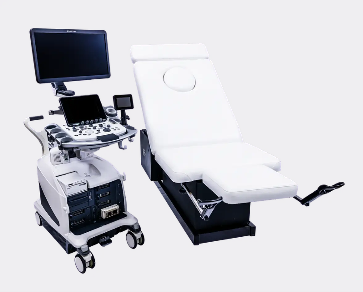 Modern white ultrasound machine with multiple screens and control panel next to a white patient examination table with leg supports.