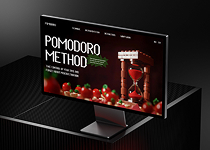 The first screen of the Pomodoro Technique website is on the monitor screen and is on the table