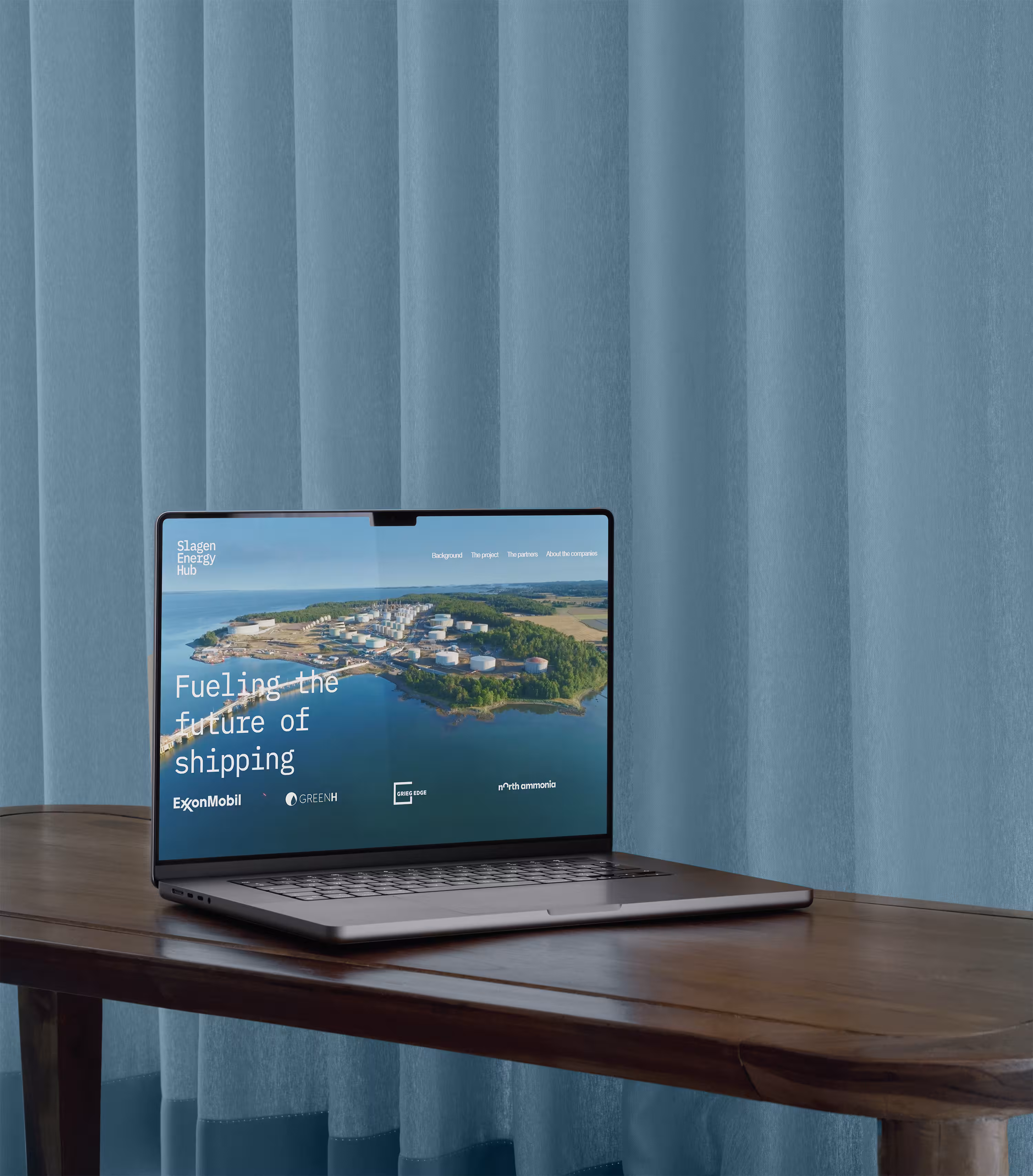 A laptop laying on the table showing the Slagen Energy Hub webstite's home page