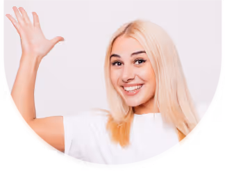 Smiling young woman with long blonde hair waving with her right hand.