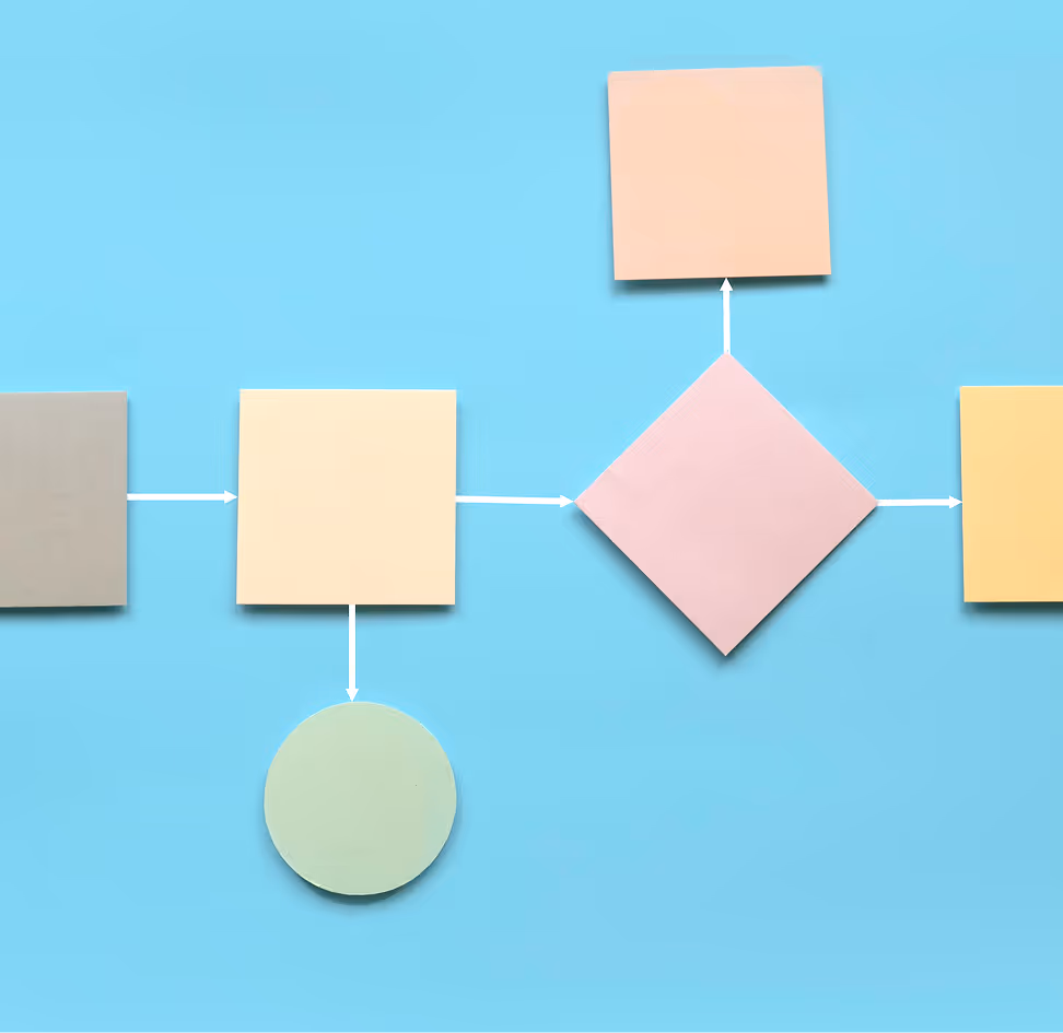 Person holding a small globe with green continents, surrounded by papers with recycling symbols and charts on a desk.