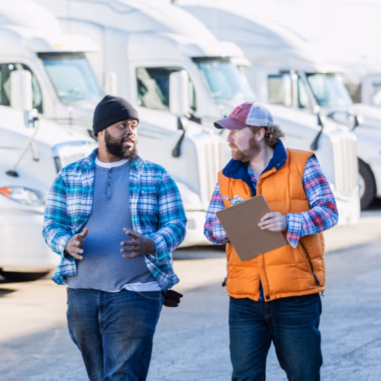 Person holding a small globe covered with green moss, pointing at it with a pen, surrounded by documents on recycling and sustainability at a meeting table.