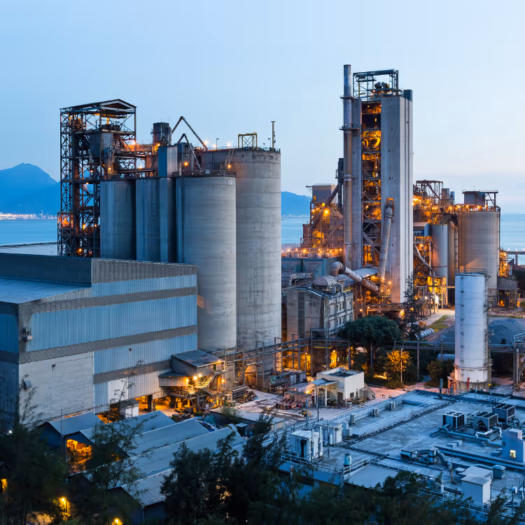 Miniature white human figures positioned on a dark circuit board with interconnected metallic pathways.