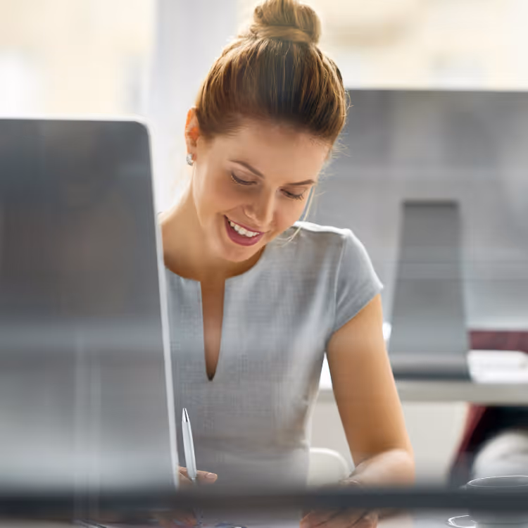 Businessman and businesswoman shaking hands in a warehouse, businessman holding contract documents.