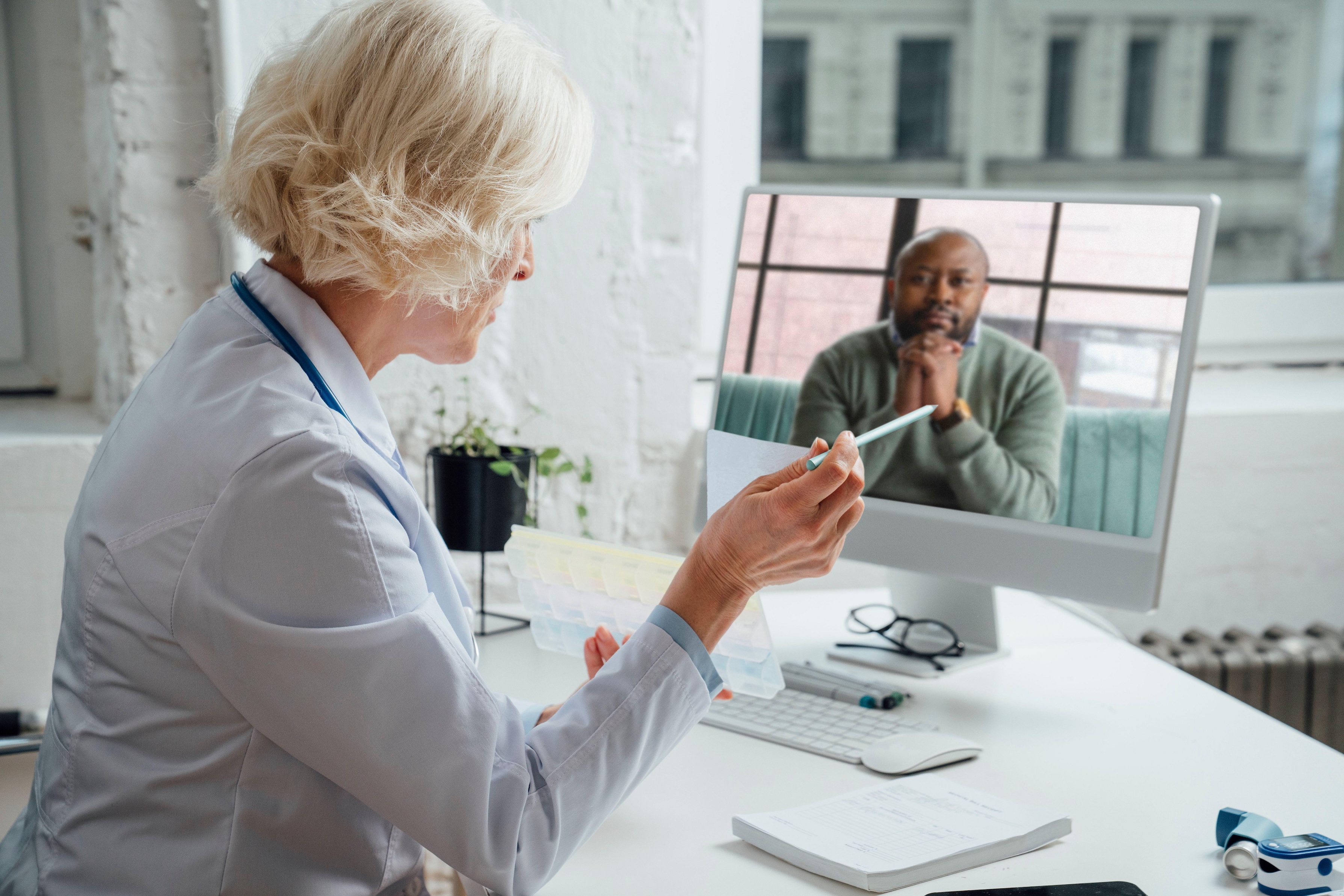 Provider speaking with a patient on a laptop