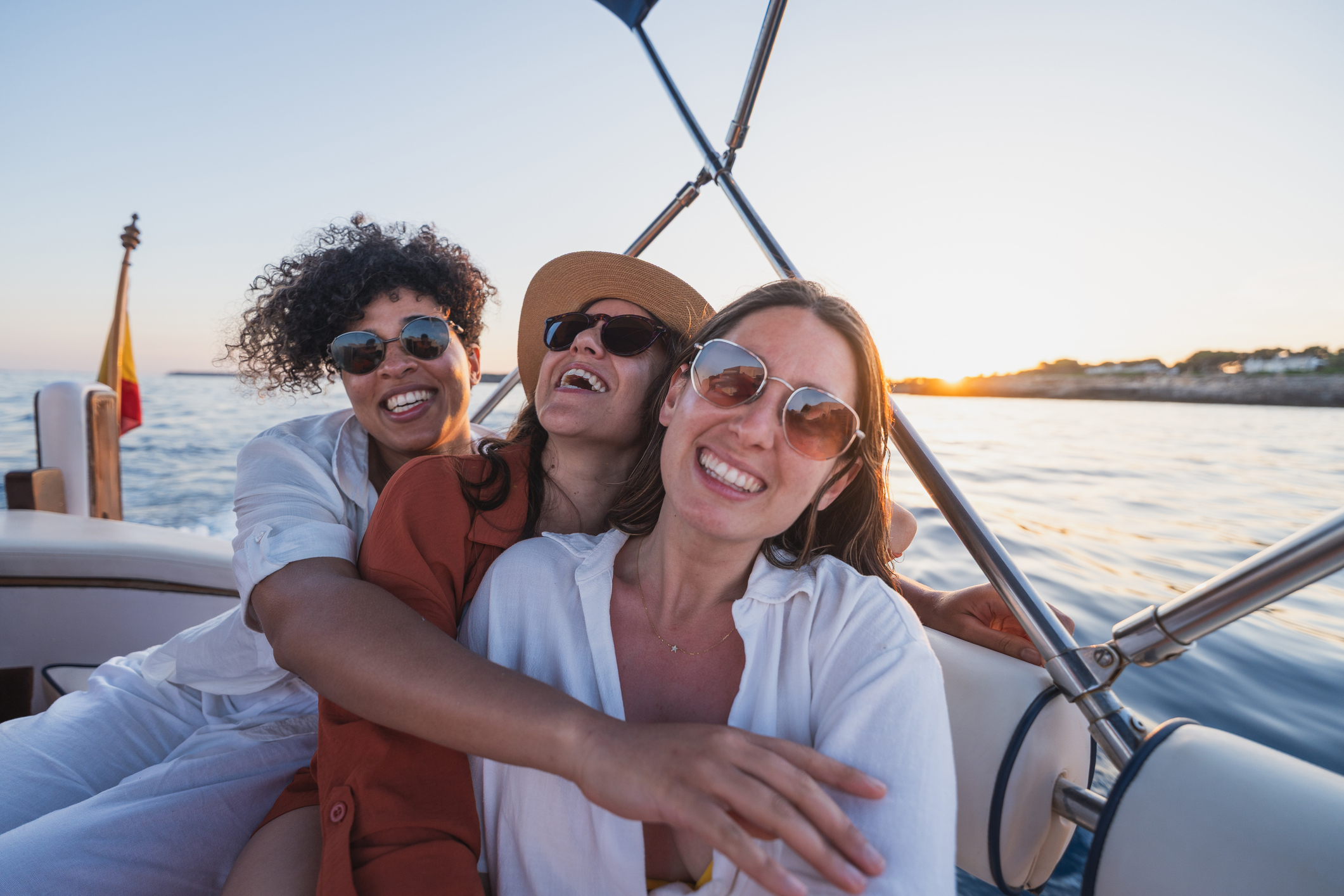 Female friends embracing and smiling while enjoying a guided fishing trip off the coast of Islamorada, FL.