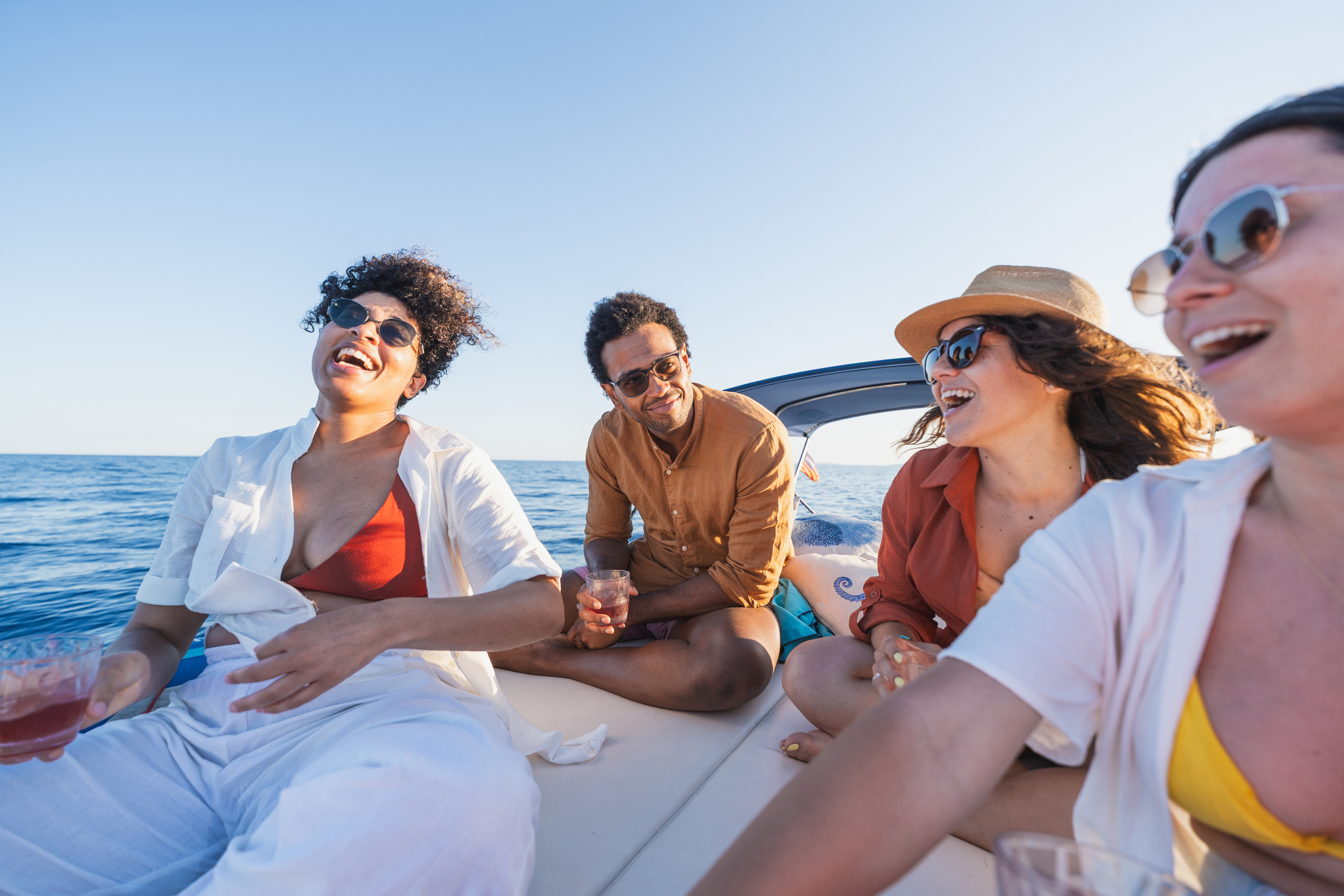 A group of friends smiling and laughing on a fishing tour in Islamorada, Florida.
