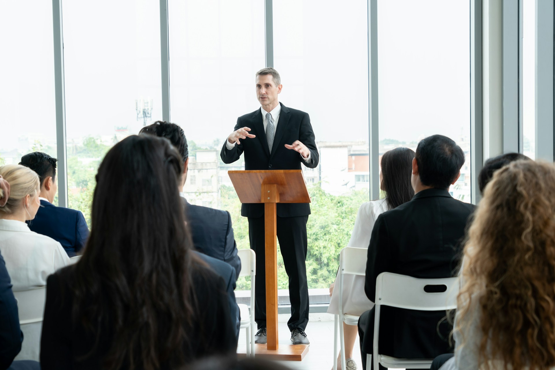 Confident leader speaking to their team in a modern office