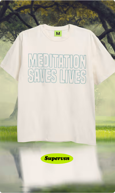 White T-shirt with light blue text 'MEDITATION SAVES LIVES' displayed in an outdoor setting with trees and grass.