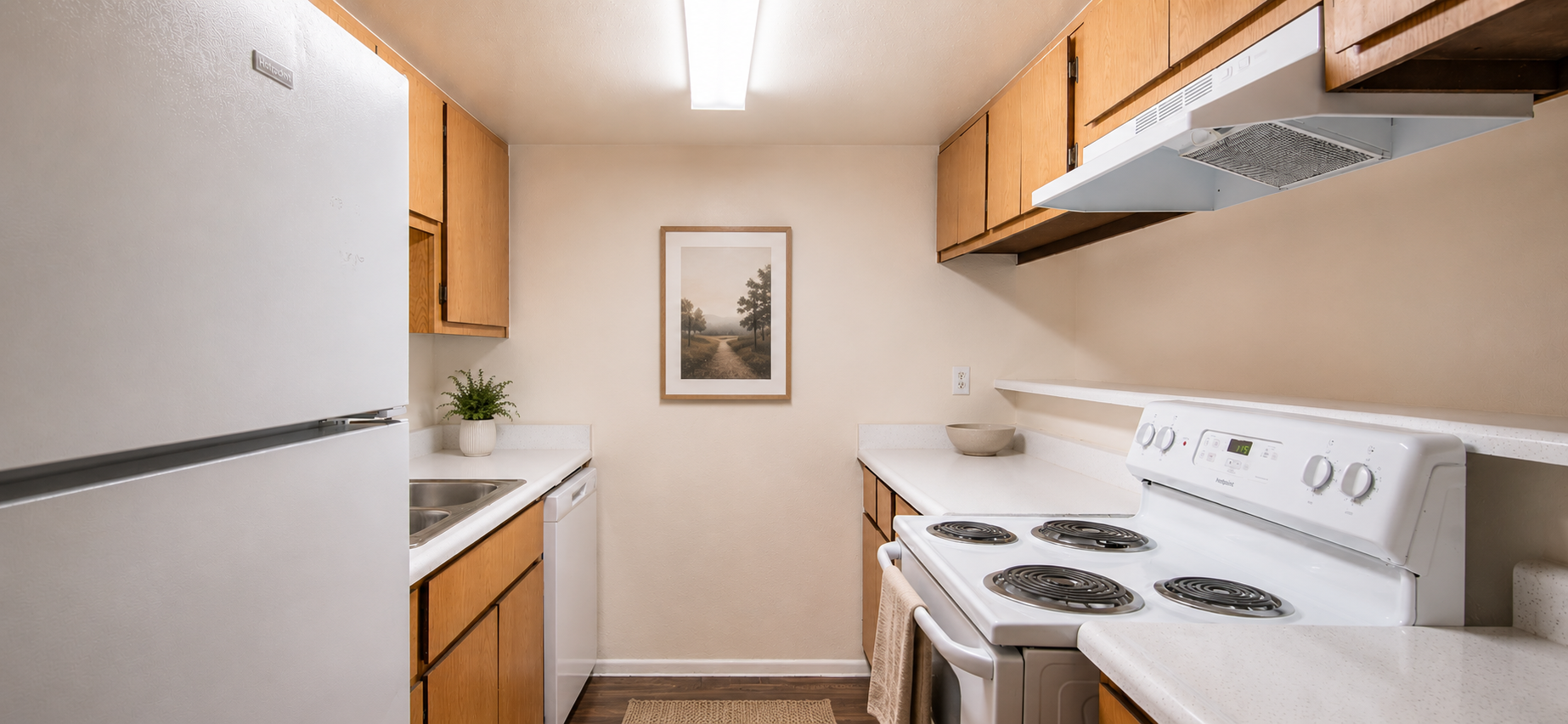 Kitchen with white appliances and wood cabinets
