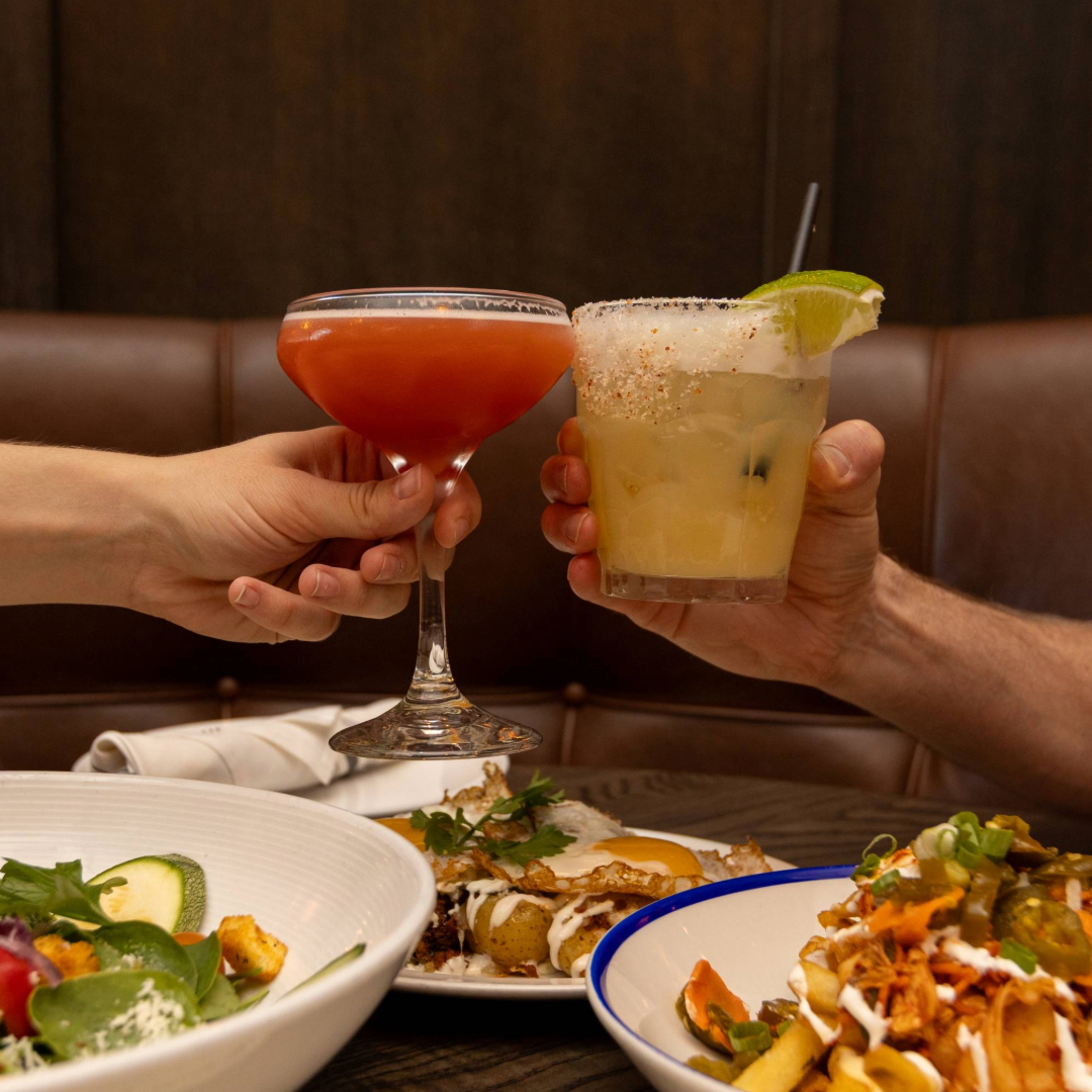 Two people cheersing at Taco Diablo Evanston