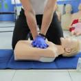 Hands demonstrating CPR chest compressions on a training manikin, representing ACI’s hands‑on face‑to‑face clinical training.
