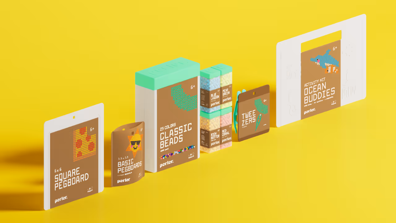 A render of the Perler packaging family, which includes pegboards, bulk beads, single beads, tweezers, and an activity kit.