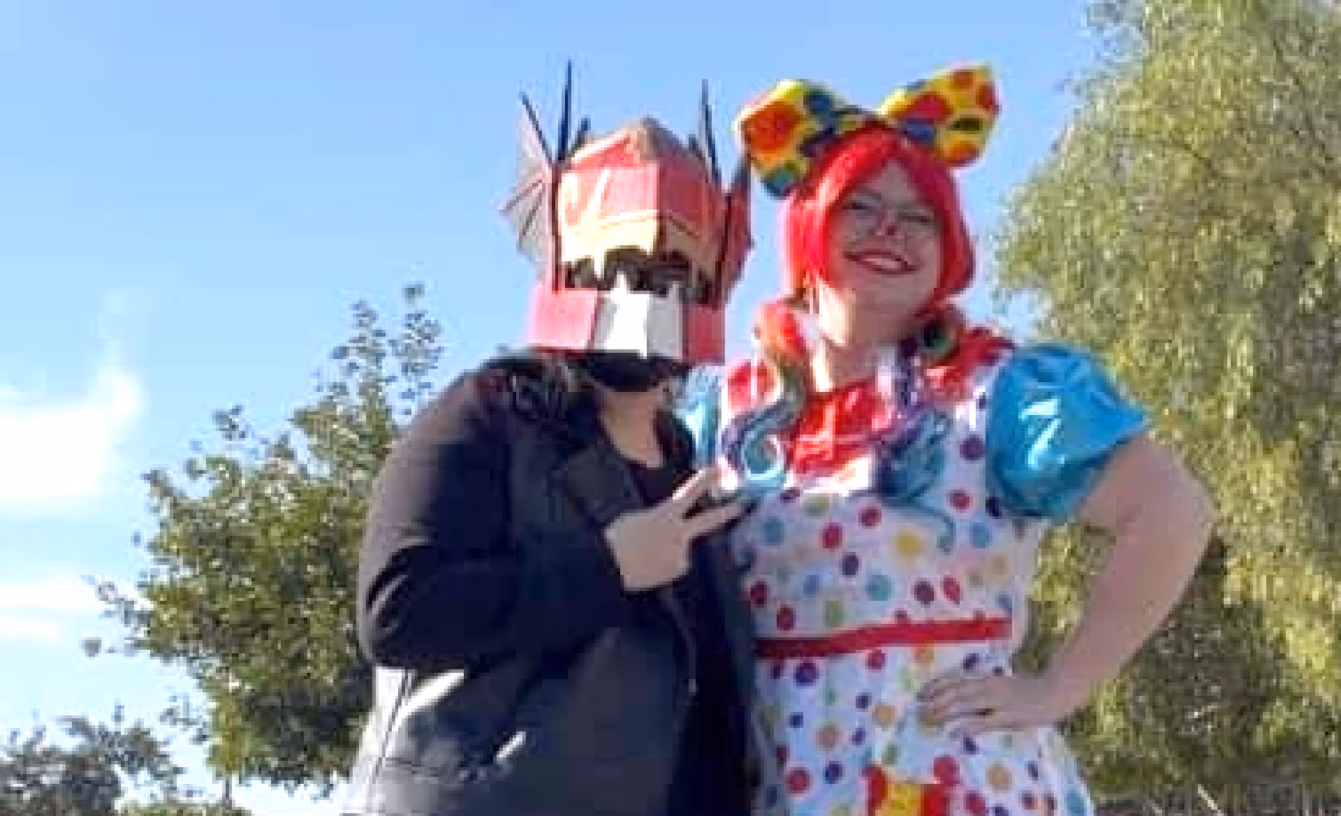 Me with my helmet, posing with someone dressed like a clown.